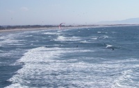 Kiteboarder mocks the bobbing surfers